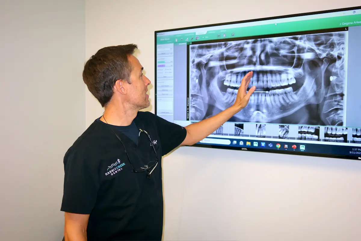 Dr. Gegzna explaining an X-ray on the operatory TV at Rabbit Creek Dental in Mobile Alabama