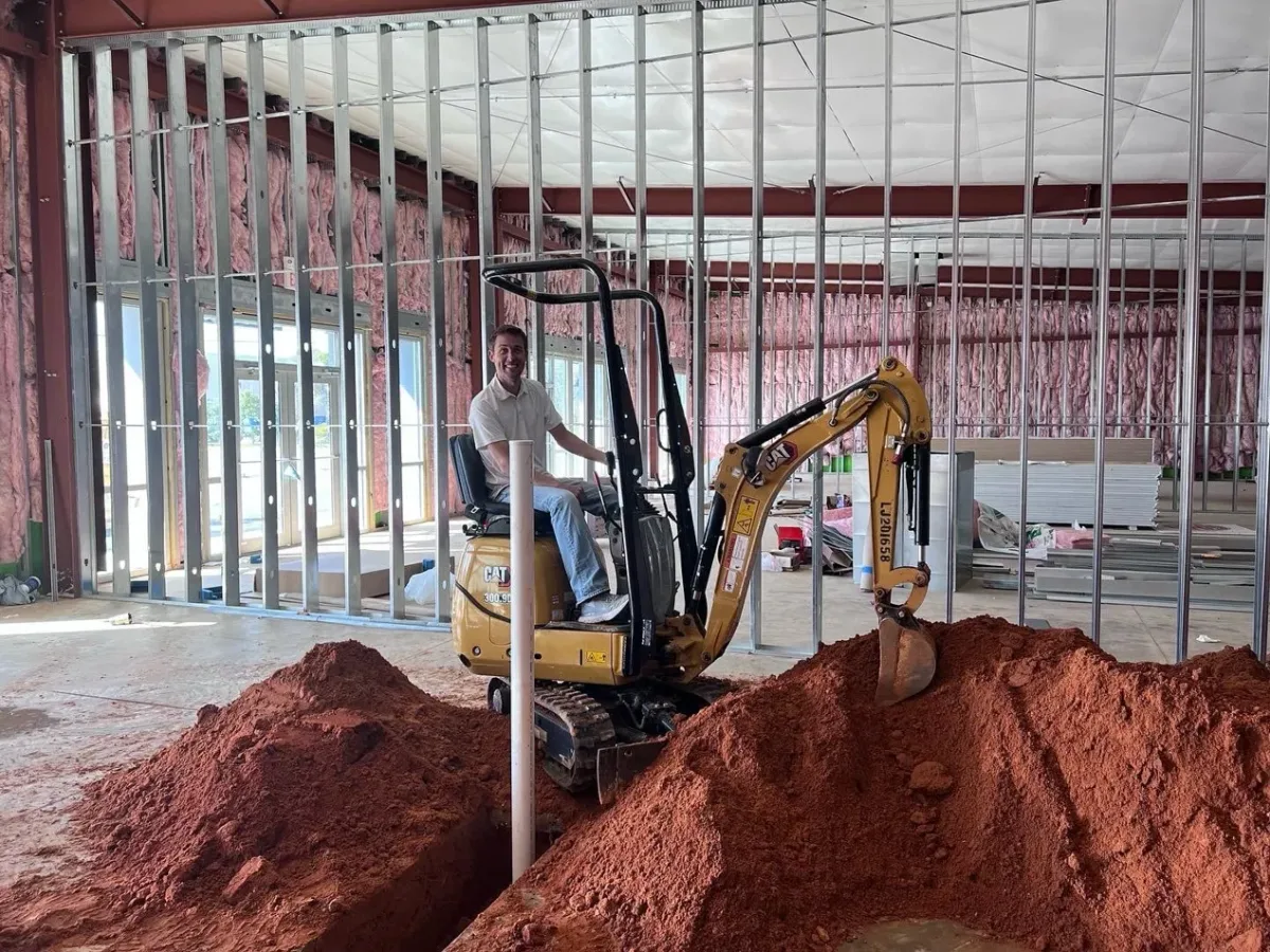Dr. Gegzna on a backhoe during construction of Rabbit Creek Dental in 2022