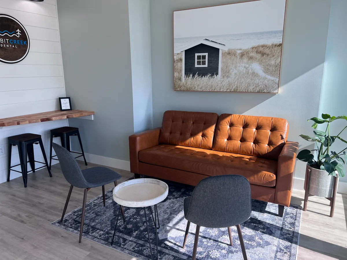 Rabbit Creek Dental waiting room with leather couch and shiplap wall